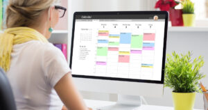 Woman working on a printable planner on the computer