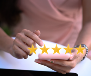 A hand with review stars