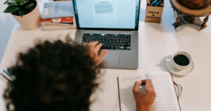 Man writing book on computer